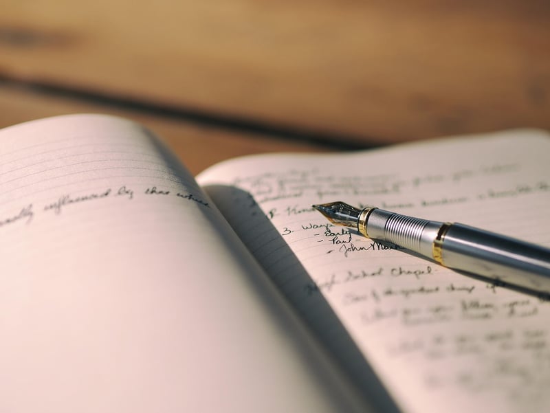 Writing desk with notebook and pen